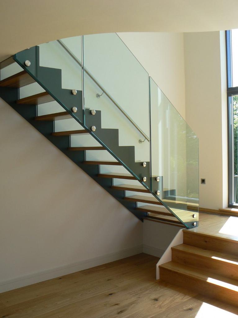 Frameless glass staircase balustrade on floating timber treads