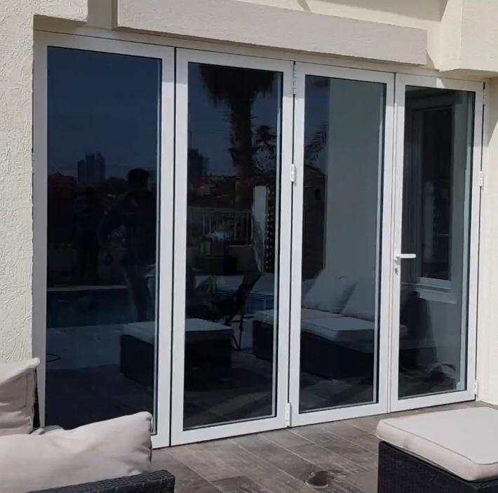 White aluminium bifold doors fitted onto a villa terrace