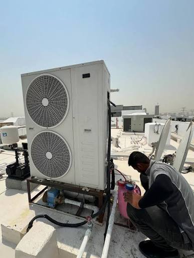 Our technician servicing a rooftop ducted AC unit in Dubai