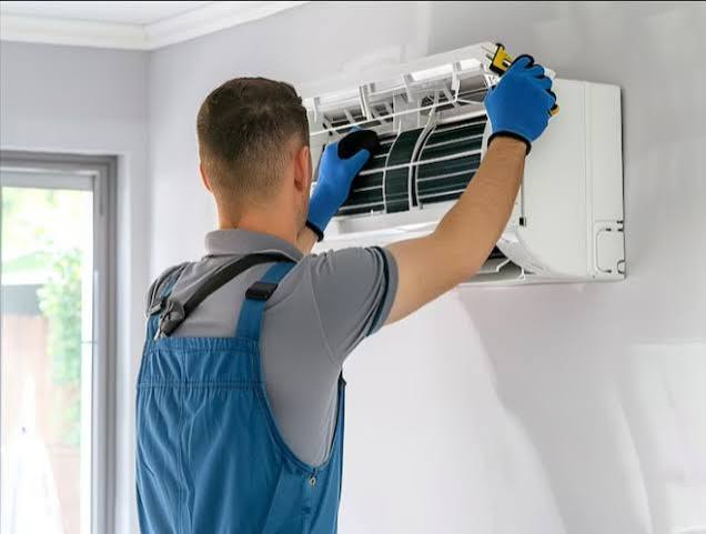 Our technician servicing a wall-mounted split AC indoor unit