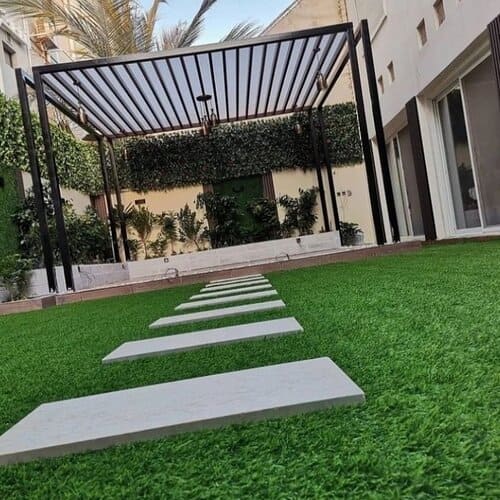 Artificial grass lawn installation with pergola and stepping stones — project 10