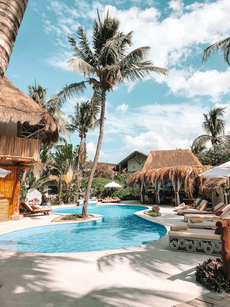 Outdoor pool area with shading structures and cabanas